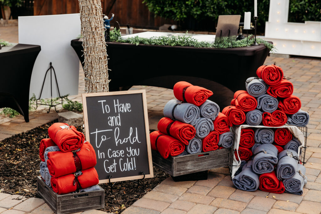 lgbtqia gothic wedding in phoenix arizona at the venue at chileens in black wedding dress red and gray blanket display