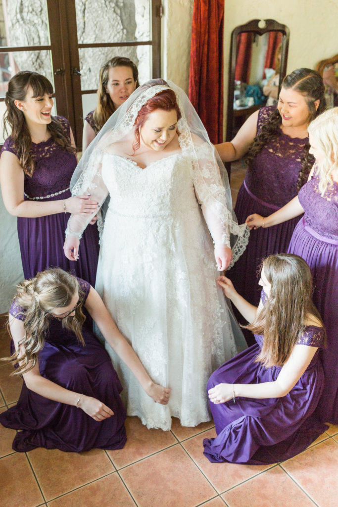 real plus size bride with long sleeve lace wedding dress