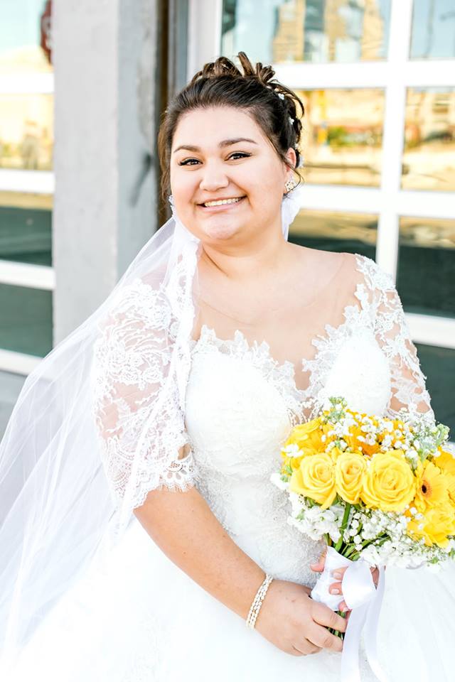 beautiful plus size bride wearing lace wedding dress with sleeves