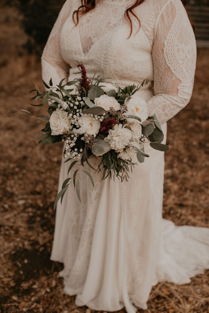 Long sleeve plus size boho wedding dress with lace and chiffon panels. 