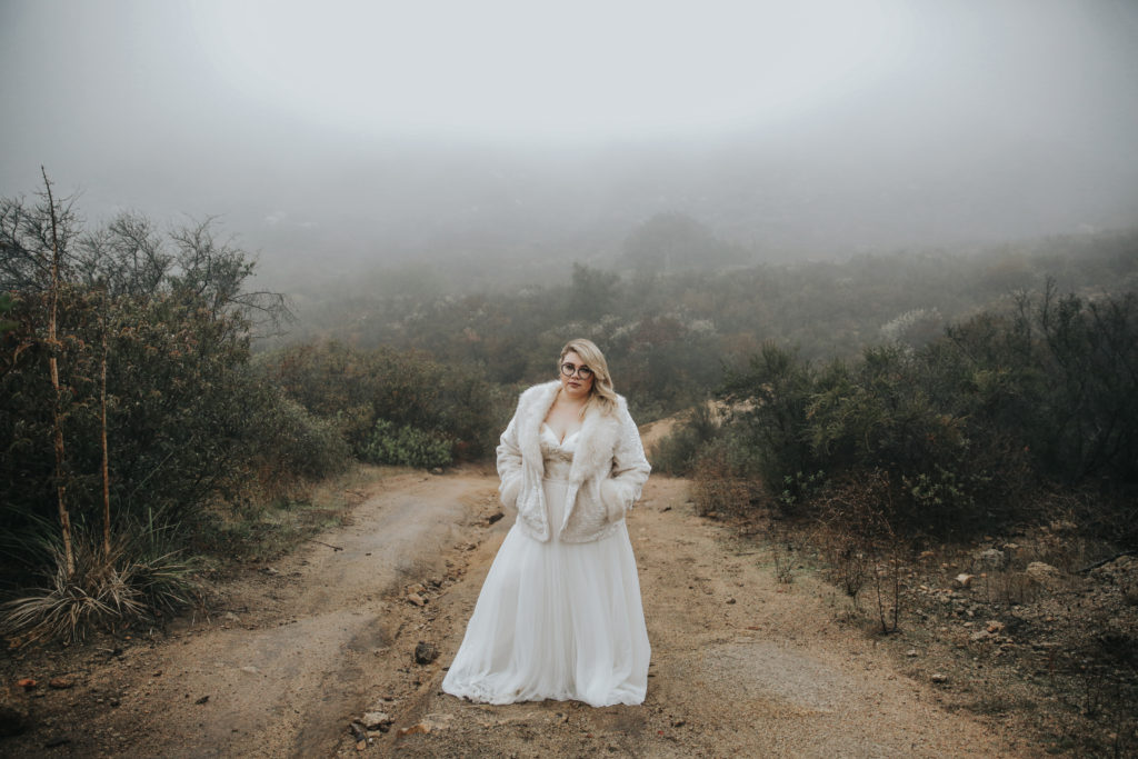 sassy plus size bride in custom wedding dress with fur coat
