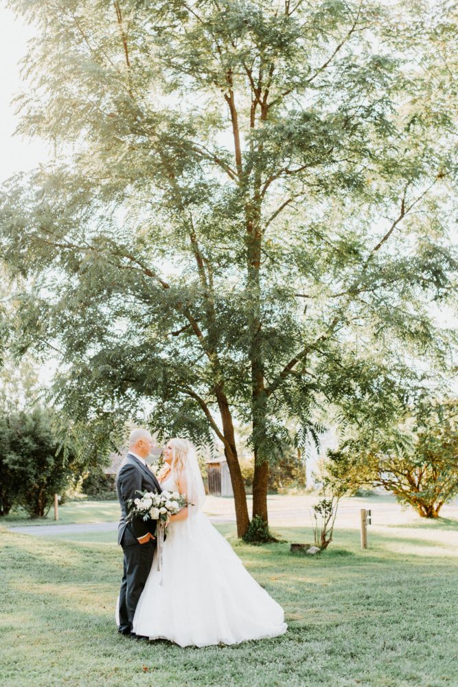 groom with curvy bride in plus size wedding dress