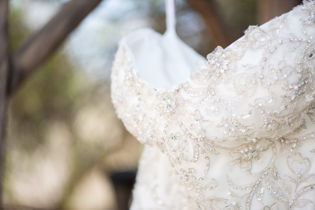 close up detail of beaded embroidery on wedding dress bodice