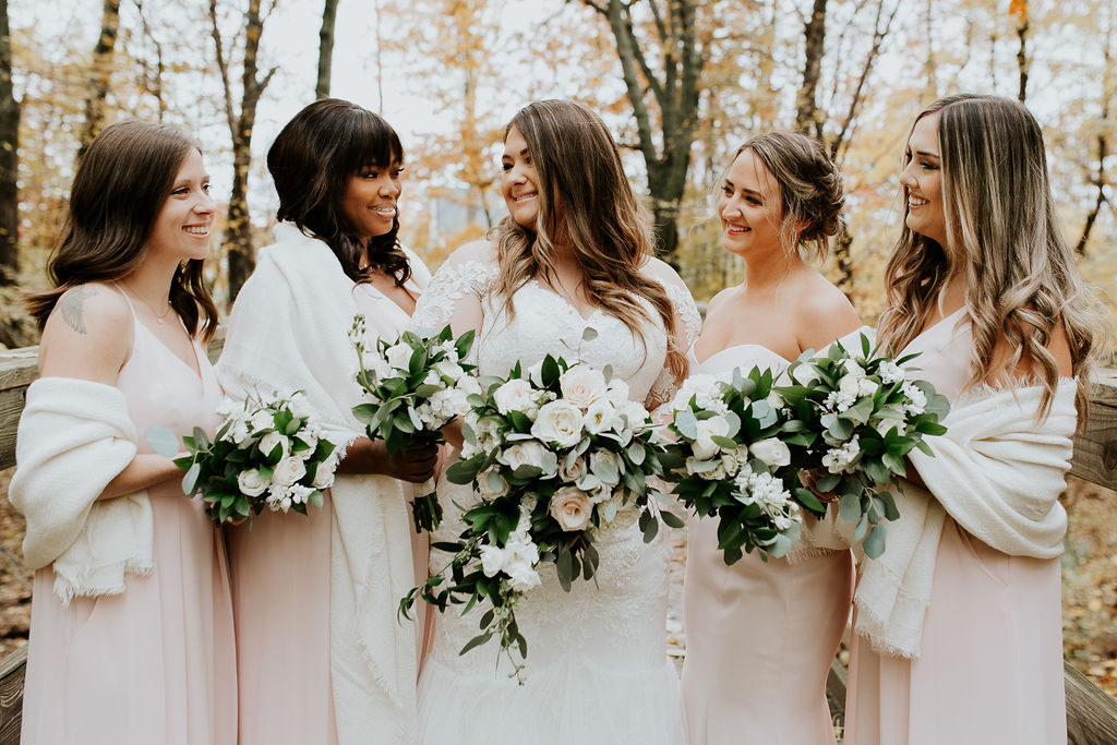 Bridesmaids wore blush pink with ivory wraps. 