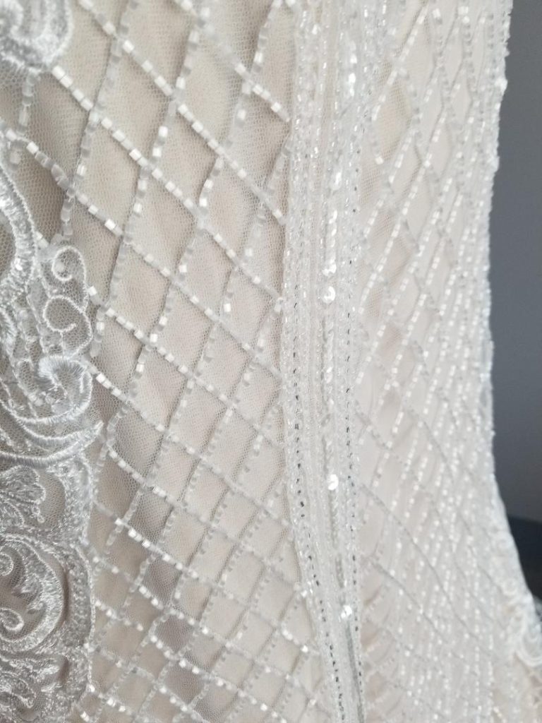 close up of hand sewn beading on wedding dress