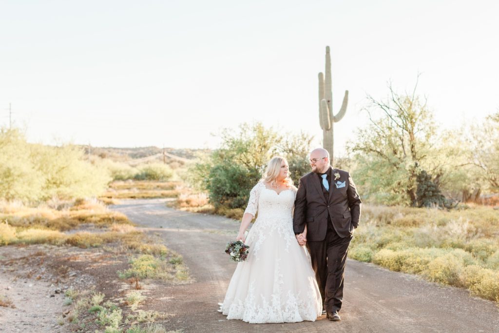 bride and groom walking in Arizona desert