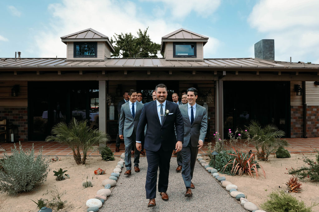 groomsmen and groom wearing suits