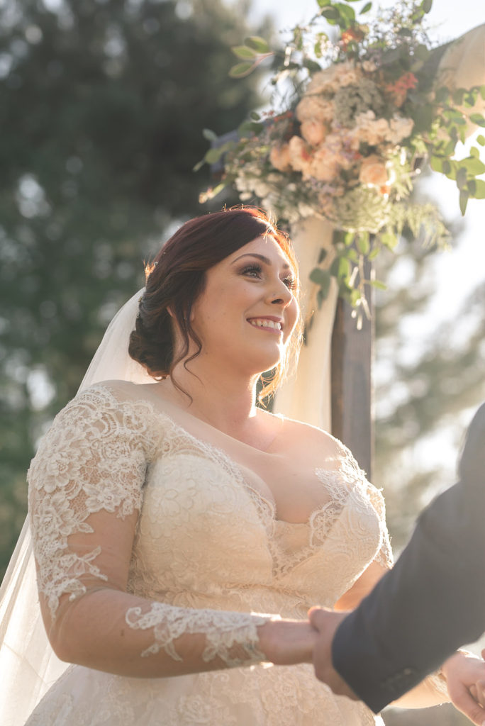 bride wearing long sleeve lace wedding dress