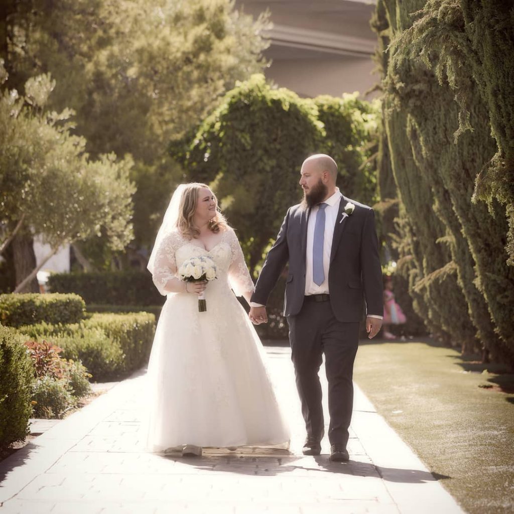 plus size bride wearing long sleeve lace wedding dress