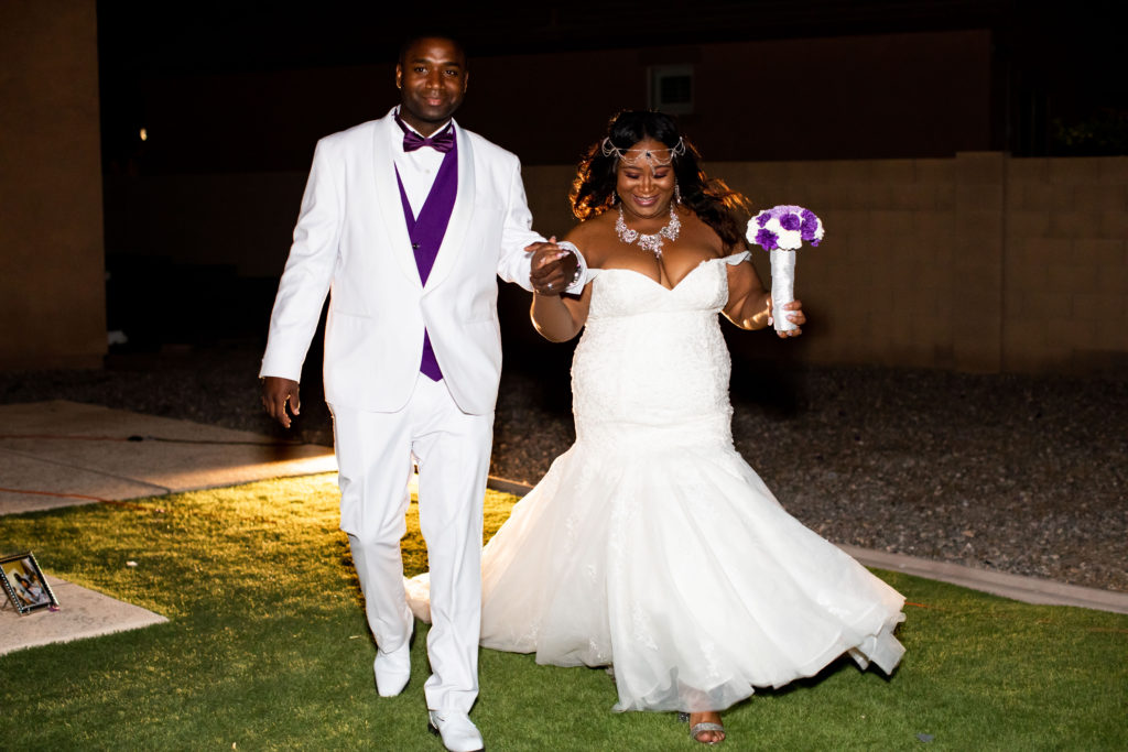 groom in white suit and plus size bride in lace mermaid wedding dress