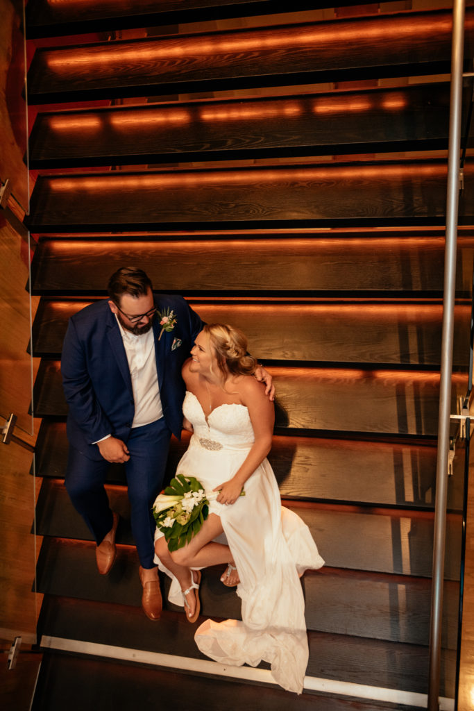 newlyweds-on-steps-curvy-bride