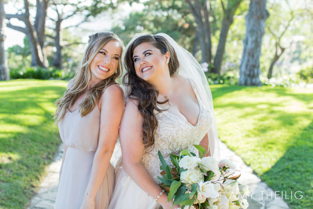 curvy-bride-and-bridesmaid-share-a-smile-california