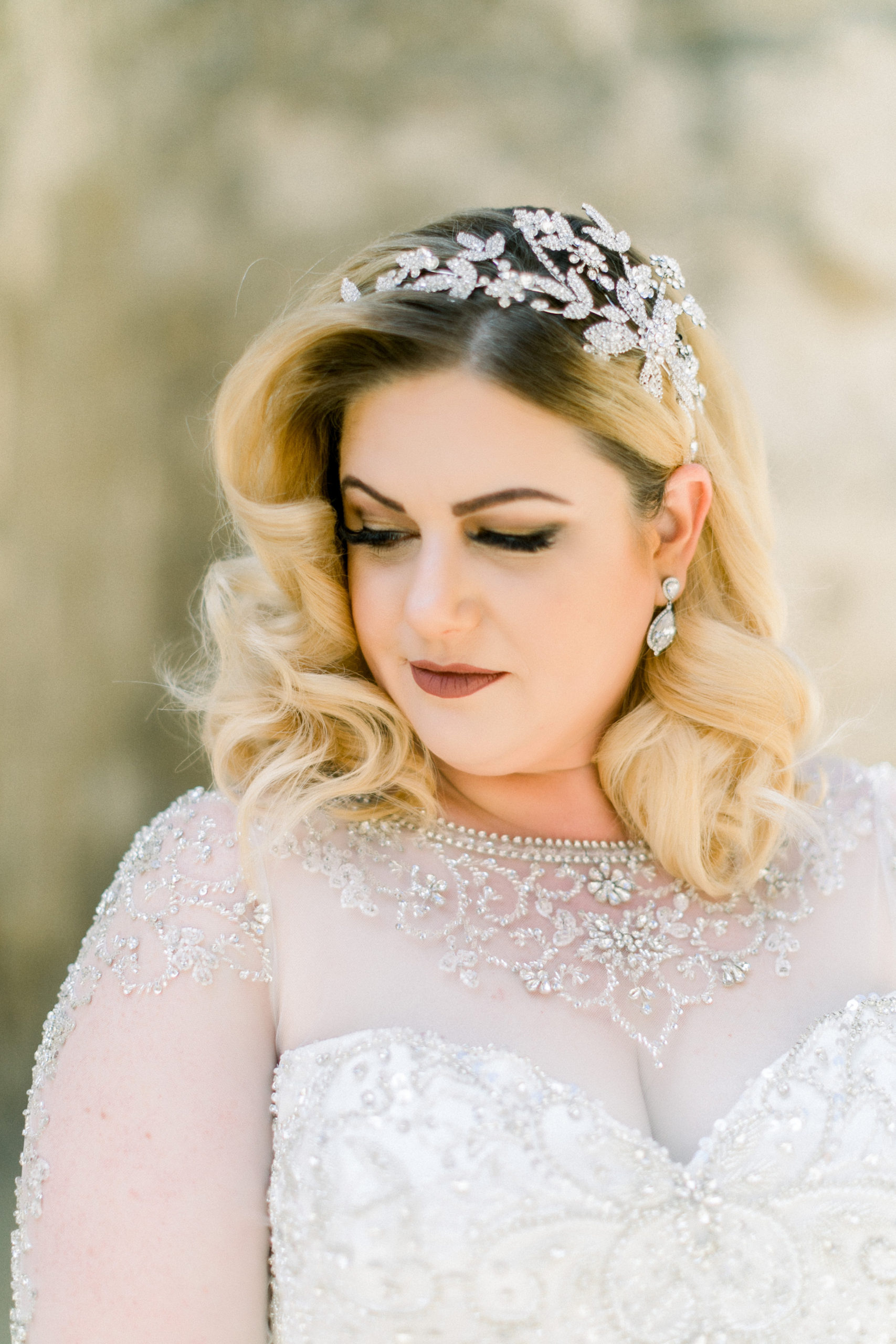 bride portrait with rhinestone headpiece and beaded long sleeves and neckline