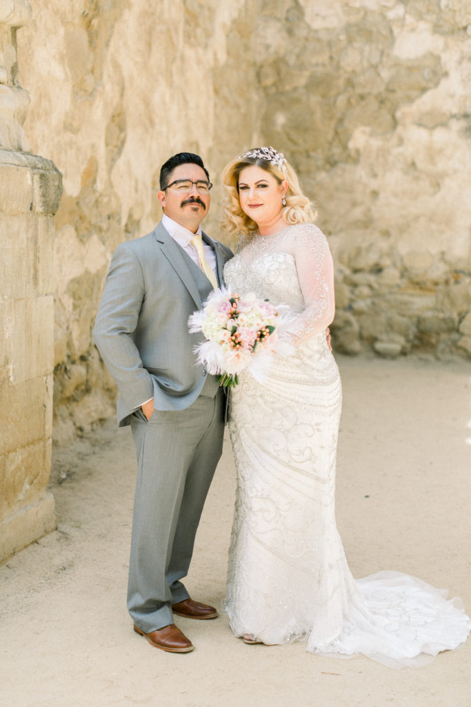 wedding couple poses at the mission san luis obsipo in california