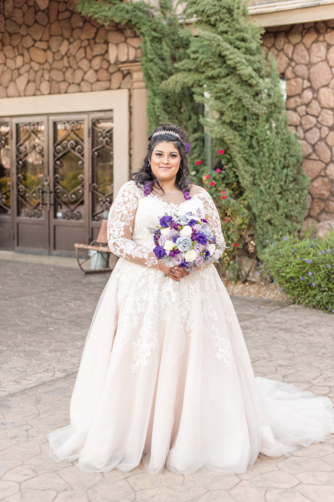 bride wearing long sleeve lace ballgown wedding dress