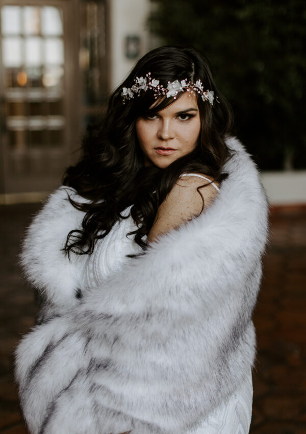 bride wearing faux fur wrap with floral headpiece