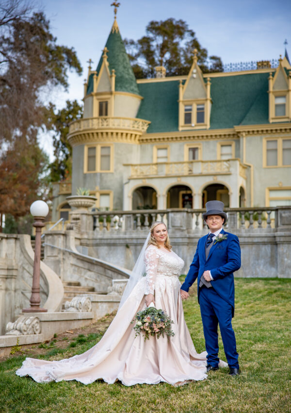 plus size bride and groom in suit outside wedding venue california