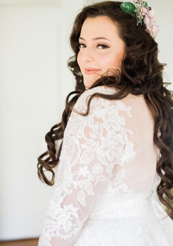 gorgeous long brown haired bride with long sleeve wedding dress