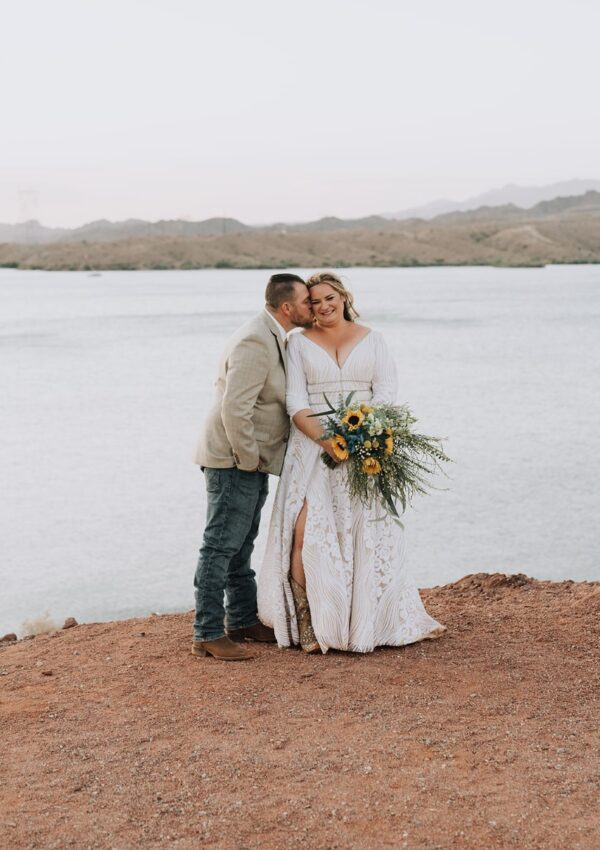 BRIDE and groom in front of lake