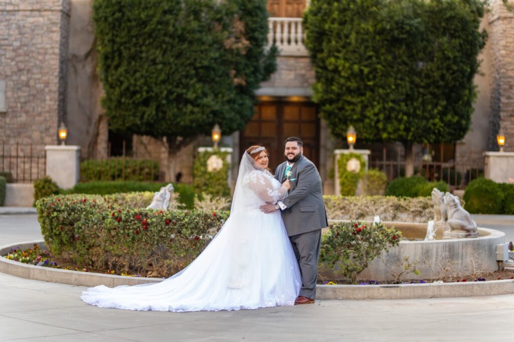 plus size couple in wedding dress and suit in garden setting