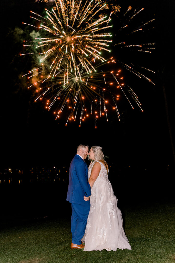 bride and groom under fireworks