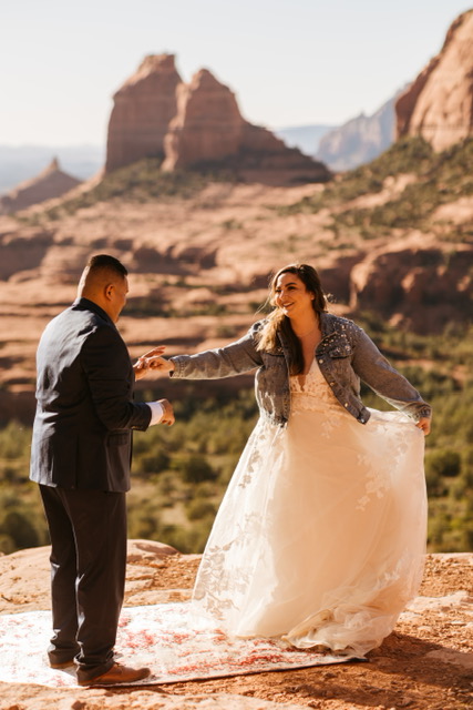 bride and groom standing on rock in sedona, arizona