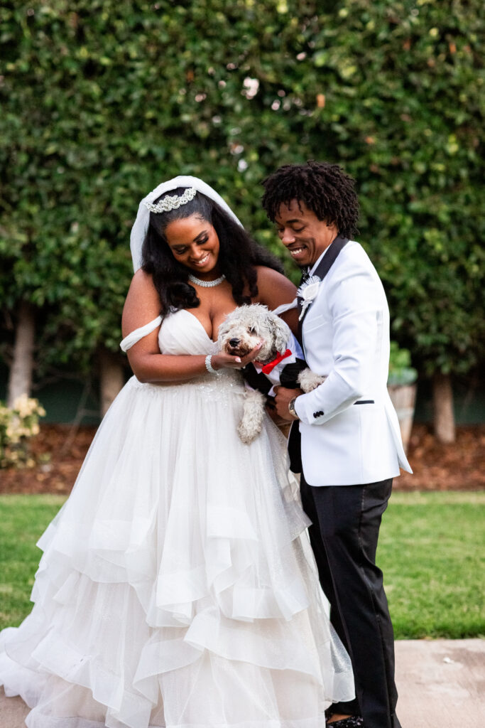 bride and groom with dog at wedding