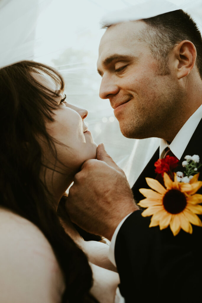 groom looking at bride and smiling