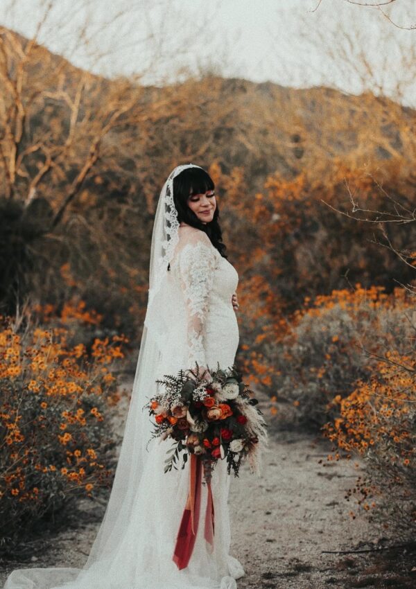 bride with baby bump long sleeve wedding dress