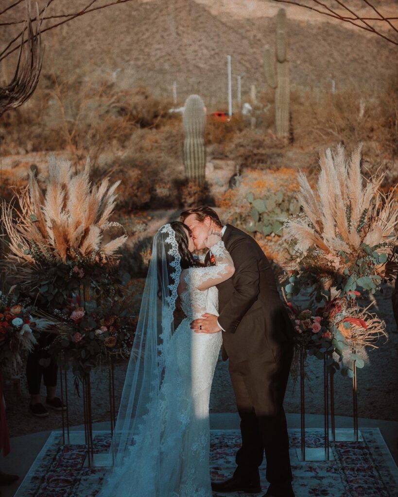 bride and groom kissing with mantilla veil