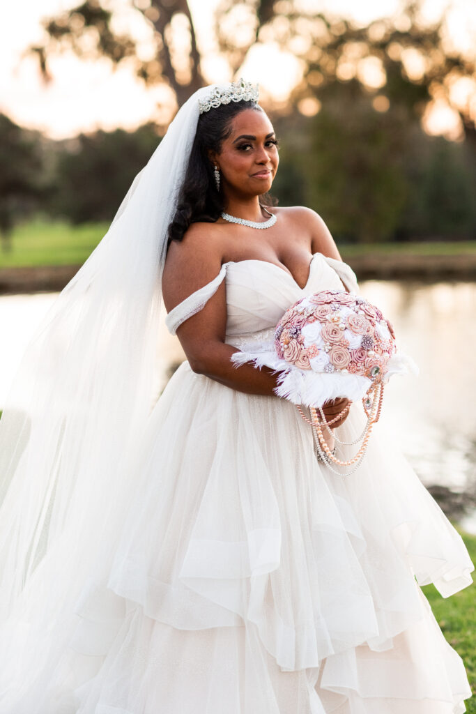 bride holding broach bouquet