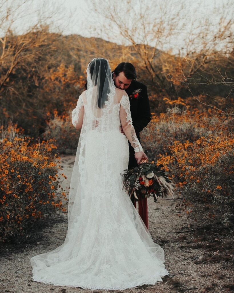bride in long sleeve wedding dress in arizona desert