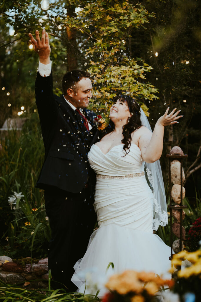 bride and groom throwing petals