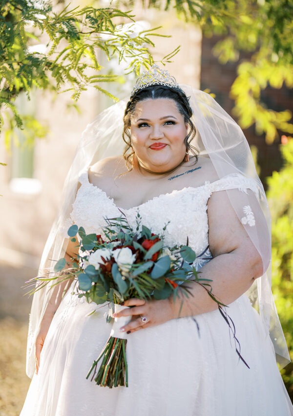 super plus size bride holding bouquet