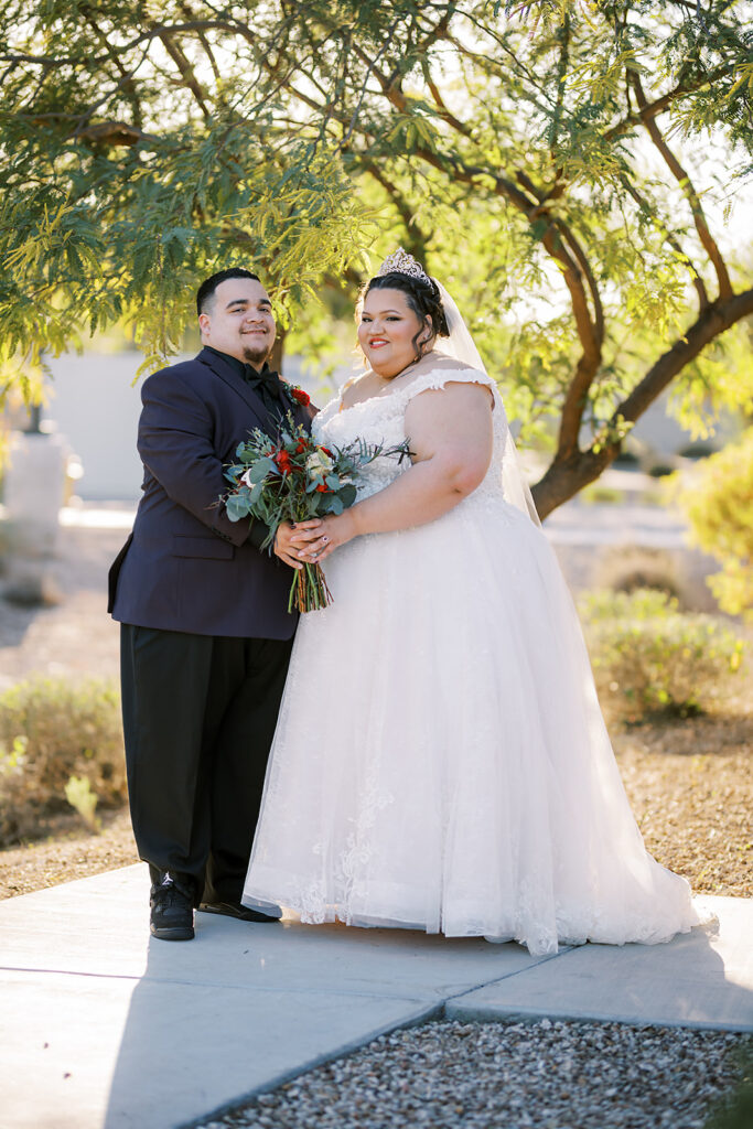plus size bride and groom holding bouquet