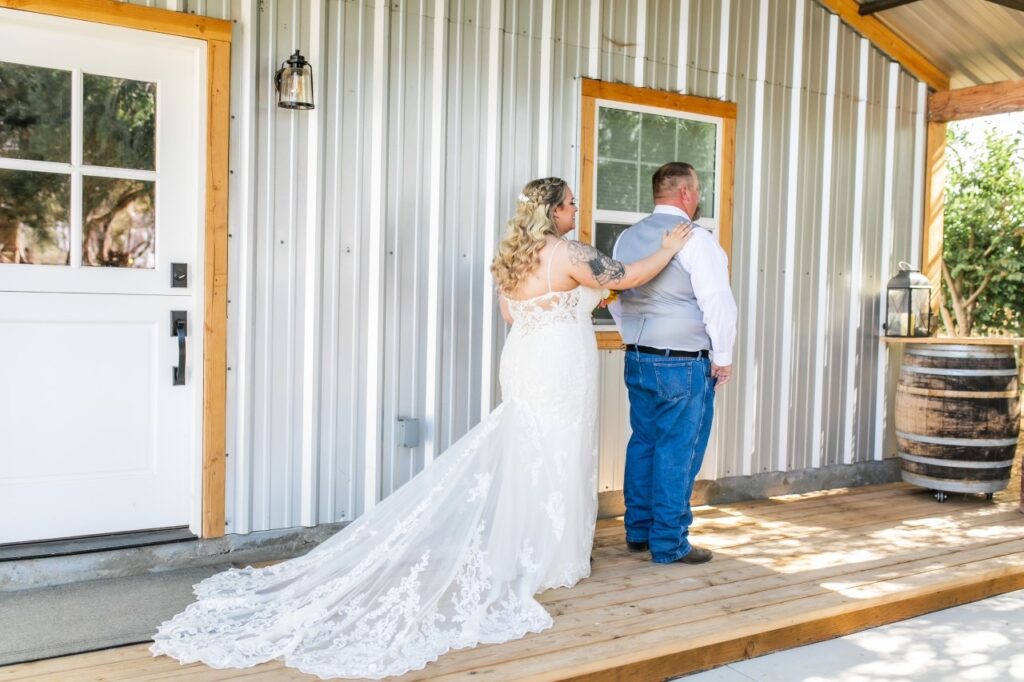 curvy bride wearing lace wedding dress with groom in jeans