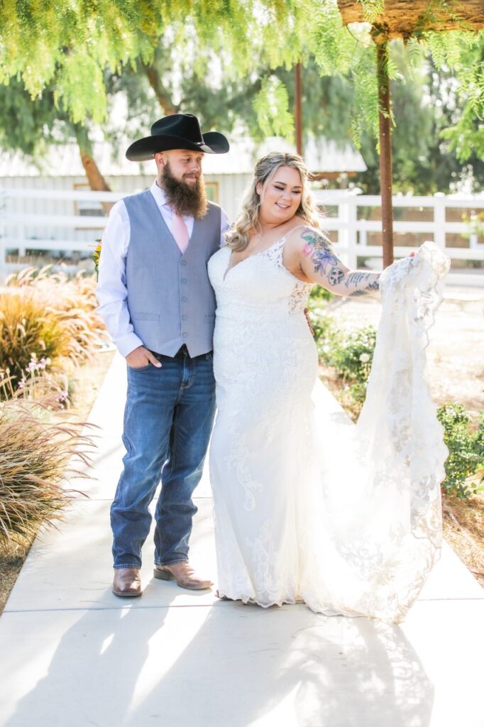 curvy bride wearing lace wedding dress with groom in jeans