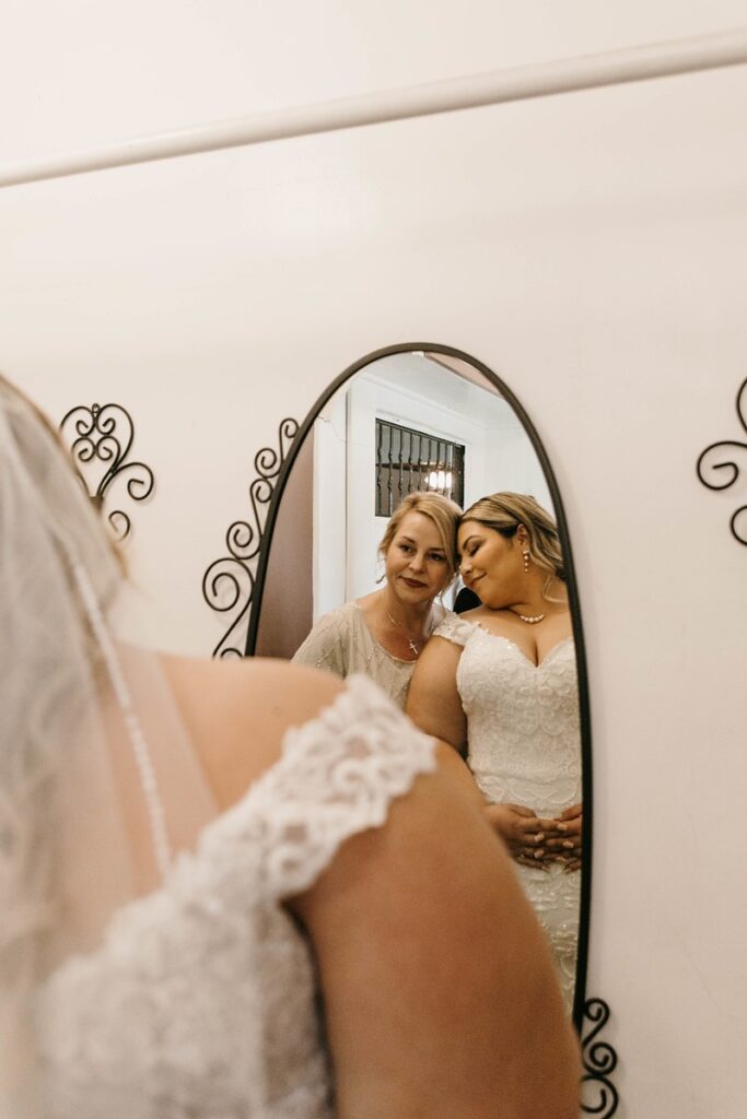 mom and bride looking in mirror