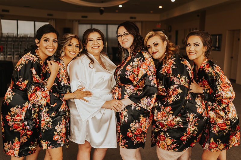 bride with bridesmaids wearing floral robes