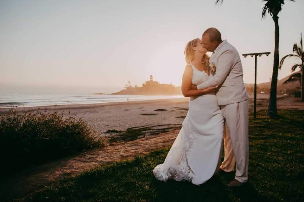 bride and groom on beach in Mexico at sunset