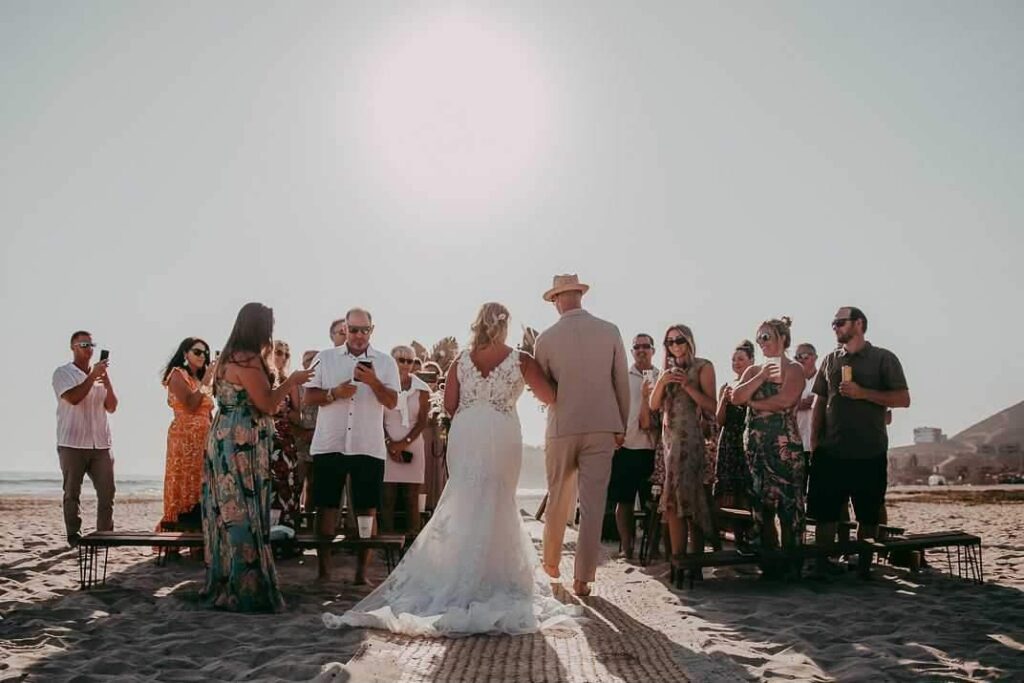 bride and groom on beach in Mexico at sunset