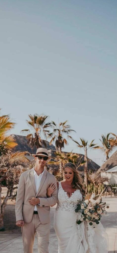 bride and groom on beach in Mexico at sunset