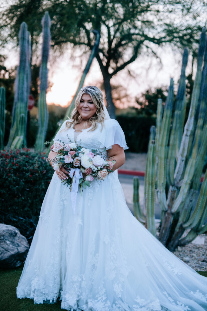 bride wearing modest wedding dress with sleeves in front of mormon temple in mesa arizona