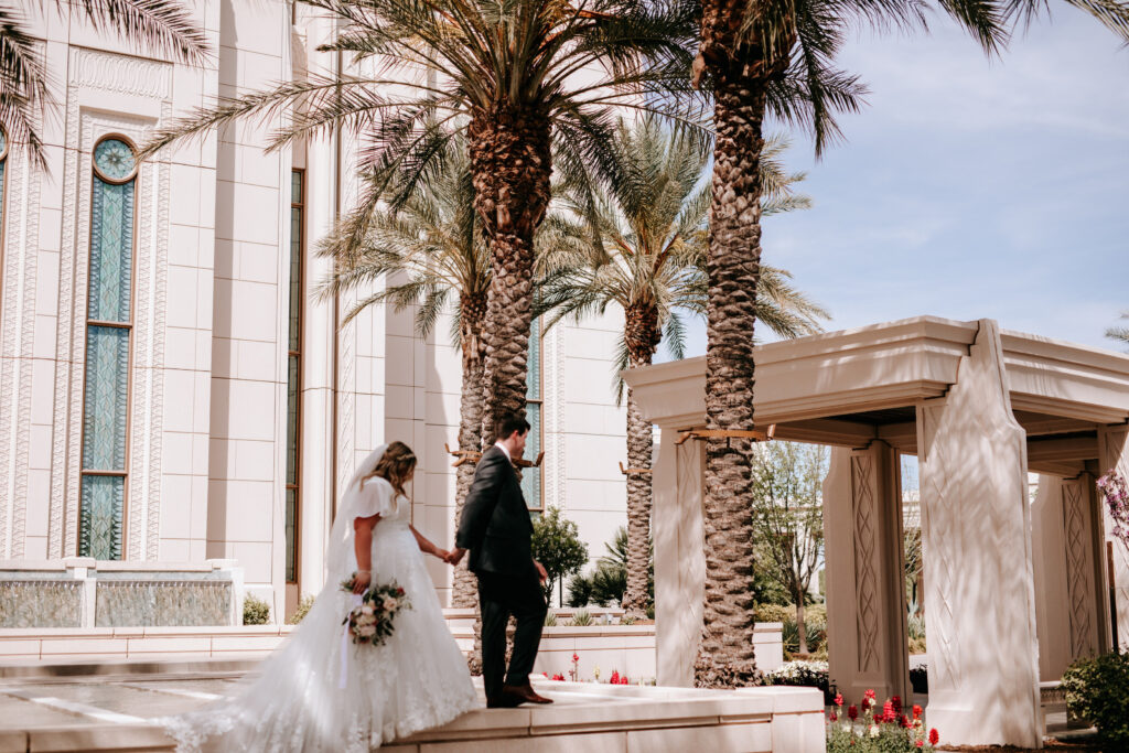 bride wearing modest wedding dress with groom in tux in front of mormon temple in mesa arizona