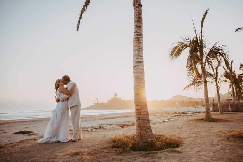 bride and groom on beach in Mexico at sunset