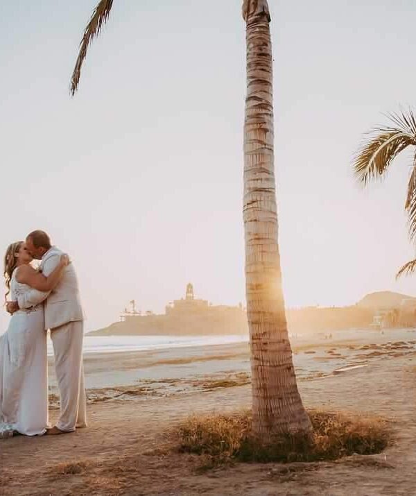 bride and groom on beach in Mexico at sunset