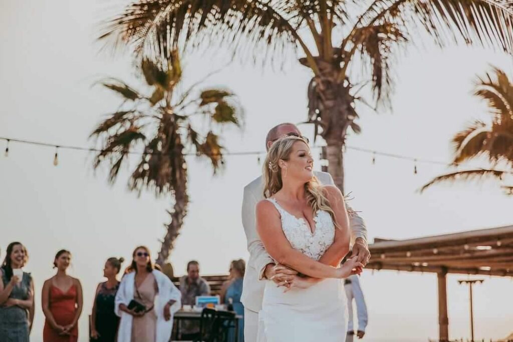 bride and groom on beach in Mexico at sunset