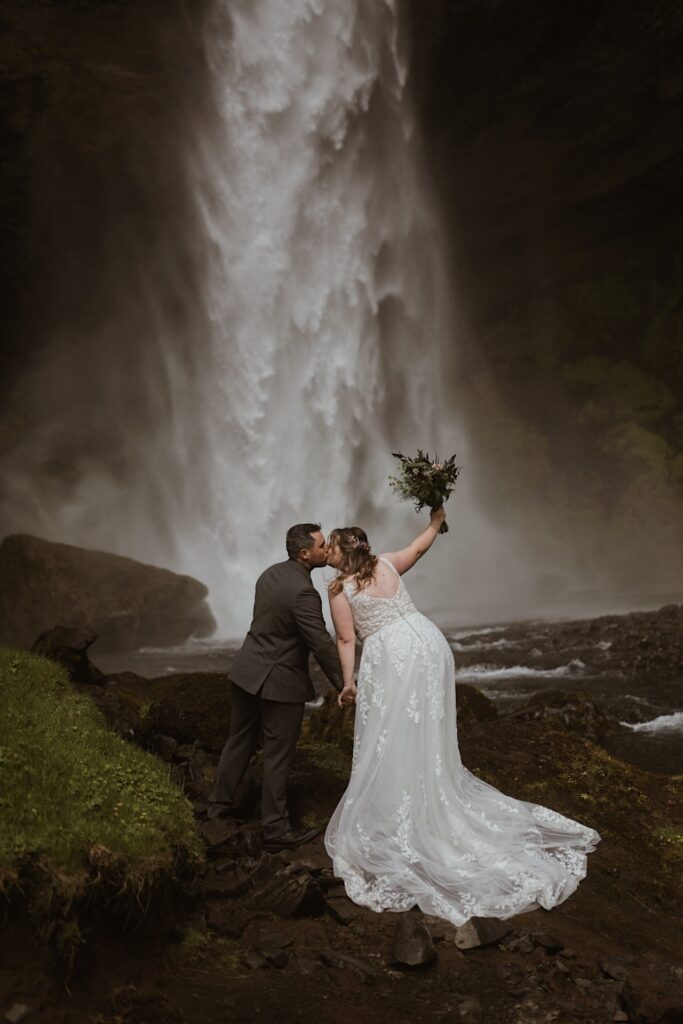 bride and groom at waterfall in iceland
