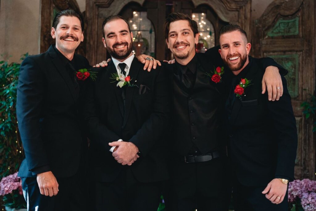 groom and groomsmen in black tuxes