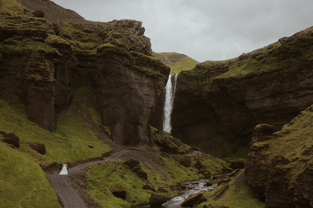 bride and groom at waterfall in iceland